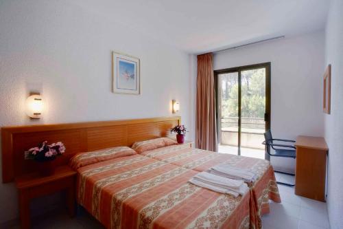 a hotel room with a bed and a window at Apart-Hotel Golf Beach 35201 in Begur
