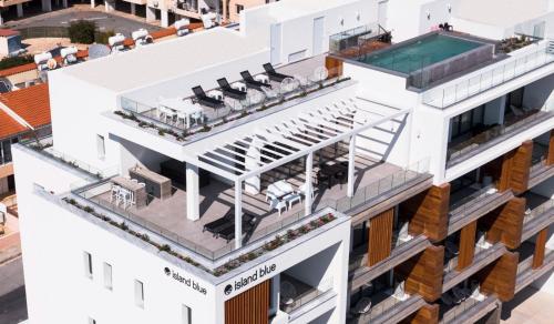 an aerial view of a white building with a swimming pool at Premier 401 3 BED in Paphos