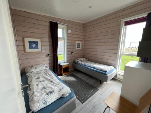 a room with two beds and a window at Ekker Island Arctic Lodge in Vadsø