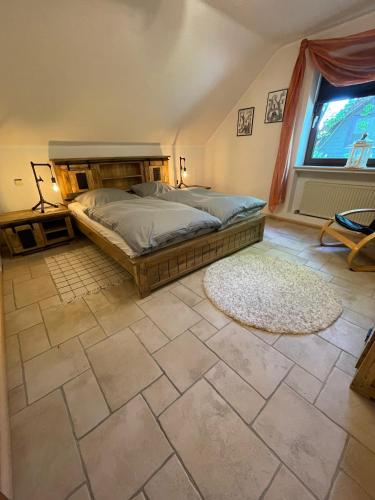a bedroom with a bed and a large window at Haus am Oberen Eschenbacher Teich in Clausthal-Zellerfeld