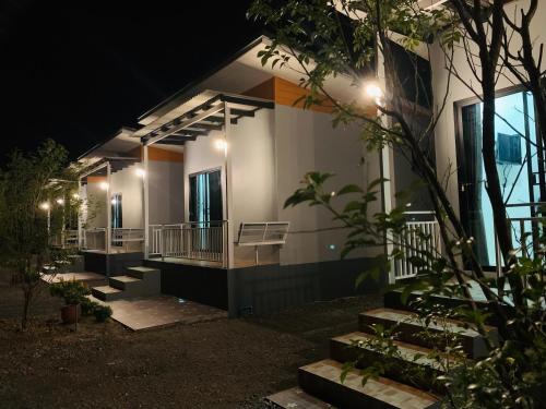 a house with a lit up facade at night at Suanvadee Resort สวนวดี รีสอร์ท in Don Sak