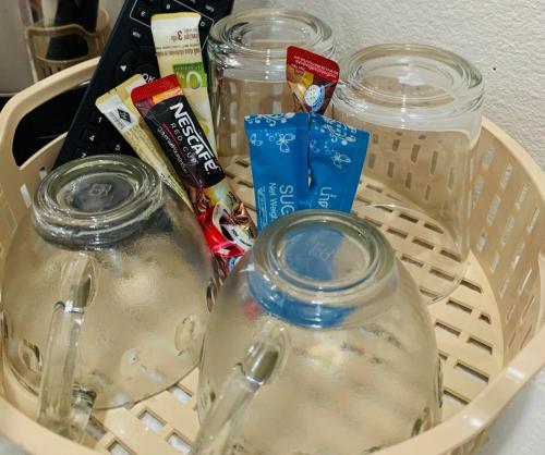 a basket with two mason jars filled with water at Suanvadee Resort สวนวดี รีสอร์ท in Don Sak