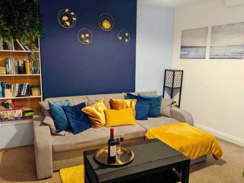 a living room with a couch with blue and yellow pillows at Winchester Retreat in Winchester