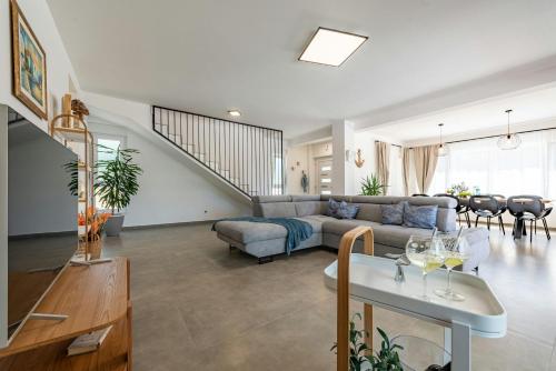 a living room with a couch and a table at Villa Molaris ZadarVillas in Donje Selo
