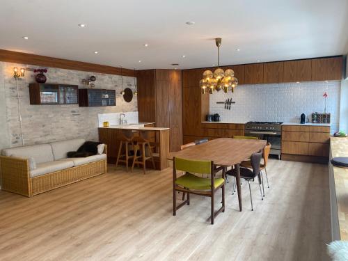 a kitchen and living room with a table and a couch at Aalborg - Beautifully renovated luxus apartment in Aalborg