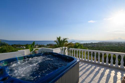 a hot tub on the balcony of a house at Villa Aegea in Kalamata