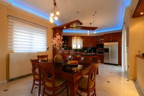 a kitchen and dining room with a table and chairs at Villa Aegea in Kalamata