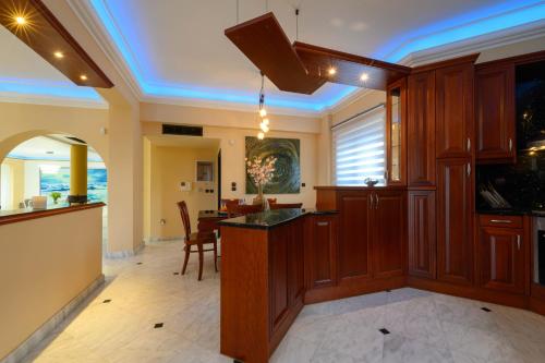 a kitchen with a bar and a dining room at Villa Aegea in Kalamata