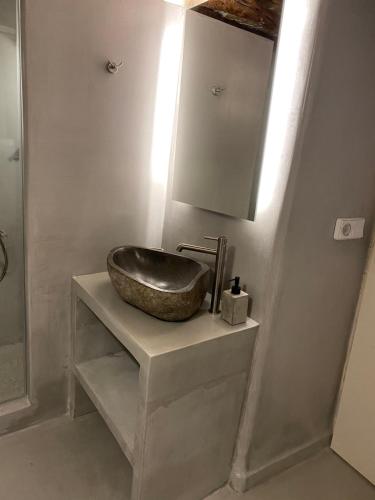 a bathroom with a sink and a mirror at Cozy apartment Kostos in Kóstos