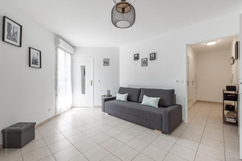 un salon avec un canapé et une table dans l'établissement Pluto's Place by Plaza, à Serris