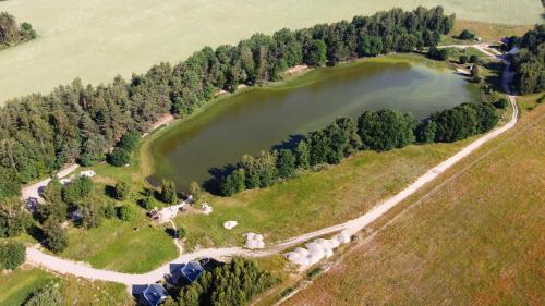 an aerial view of a lake in a field at OSTOJA PAWIE OKO in Potęgowo