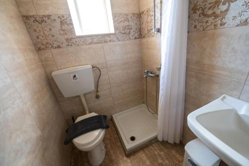 a small bathroom with a toilet and a sink at Bikakis Family Apartments in Kissamos