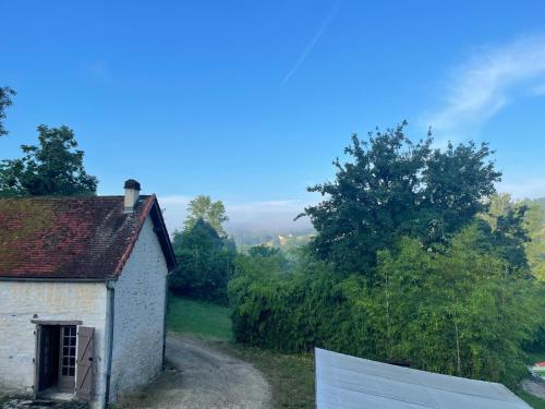 a small white house with a sign in front of it at Domaine du Bonheur en Pierre avec Piscine, Proche Sarlat in Carlux