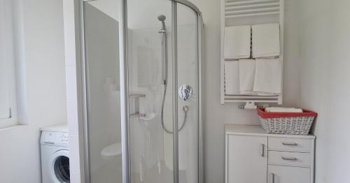 a shower in a bathroom with a washing machine at Apartment Traube - Stelvio in Stelvio