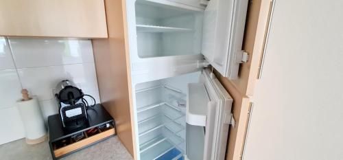 a white refrigerator with its door open in a kitchen at Apartment Traube - Stelvio in Stelvio