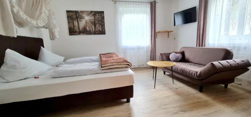 a living room with a bed and a chair at Apartment Traube - Stelvio in Stelvio