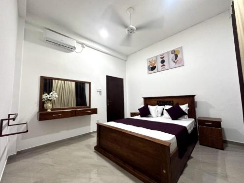 a bedroom with a bed and a window at DreamScape Holiday Apartment in Kalutara