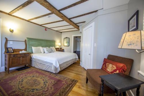 A bed or beds in a room at Abalonia Inn