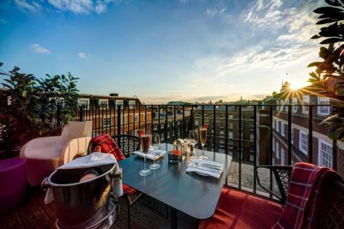 a table on a balcony with a view of the city at Apex Temple Court Hotel in London