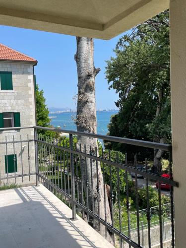 a view from the balcony of a house with a tree at Seaside apartments in Kaštela