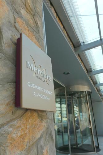a sign on the side of a building at Mercure Quemado Al-Hoceima Resort in Al Hoceïma
