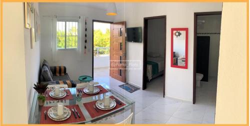 a living room with a couch and a table at Espaçosos Aptos em Porto de Galinhas - Condominio com Piscina - Perto de tudo! in Porto De Galinhas