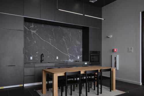 a kitchen with a wooden table and black cabinets at South Boston studio w wd nr red line BOS-888 in Boston