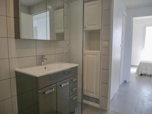 a bathroom with a sink and a mirror at Appartement rénové en plein centre de Palais avec cour ensoleillée, proche du port, animaux acceptés - FR-1-418-222 in Le Palais