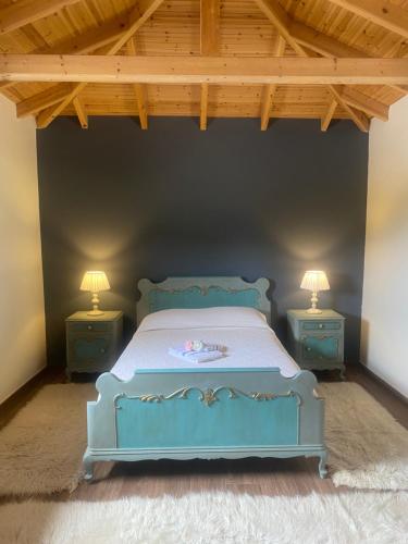 a bedroom with a blue bed with two night stands at HEAVEN HOUSE in Kavala