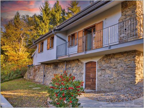 a building with a balcony on the side of it at Foresteria Lombarda San Rocco in Colico
