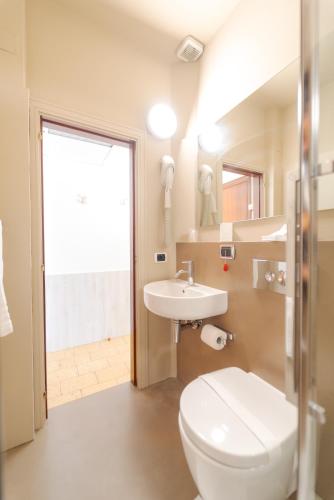 a bathroom with a white toilet and a sink at Hotel Beach in Tortoreto Lido
