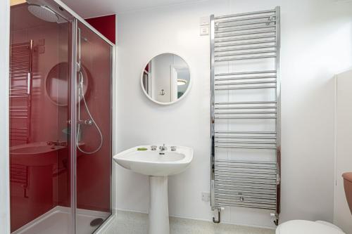 a bathroom with a sink and a shower at Angorfa in Caernarfon