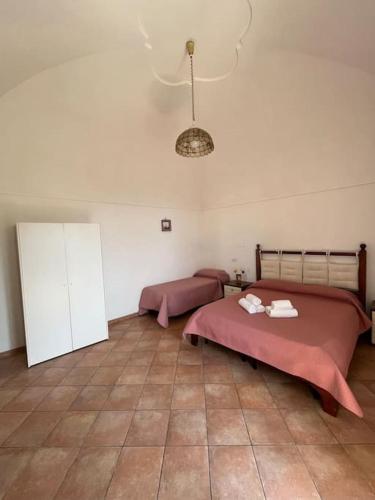 a bedroom with two beds and a tile floor at Farm seaview on Capri in Termini