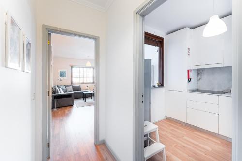 a kitchen and living room with white cabinets at Dream Views of Porto - Private Apt in Gaia by Lisbeyond in Vila Nova de Gaia