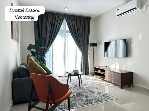 a living room with a couch and a tv at Teratak Desaru Homestay Wi-fi, Smart TV & Water Dispenser in Bandar Penawar