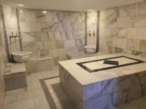 a bathroom with two toilets and a tub and a sink at La Vie En Rose Hotel by Sogutdagi Isparta in Keçiborlu