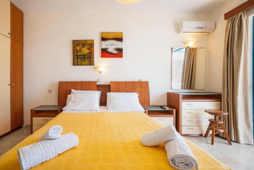 a bedroom with a bed with two towels on it at Livadia Beach Studio A in Livadia
