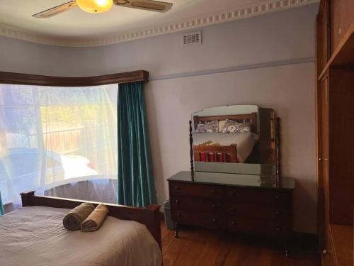 1 dormitorio con cama, tocador y espejo en Cheerful home in Newport, en Newport