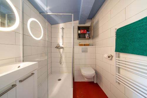 a white bathroom with a toilet and a sink at Catherine Studios in Aix-en-Provence