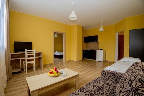 a living room with a bed and a table in a room at Thermal Hotel Seven Seasons in Banya