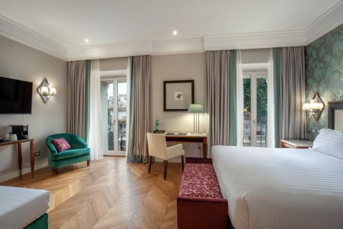 a hotel room with a bed and a desk at Rose Garden Palace Roma by OMNIA hotels in Rome