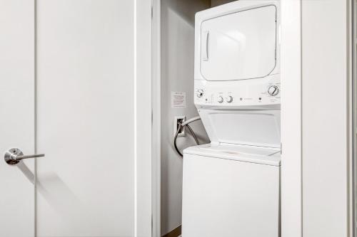a microwave sitting on top of a washer and dryer at Brighton 1BR w WD Gym nr T Shops Dining BOS-435 in Boston