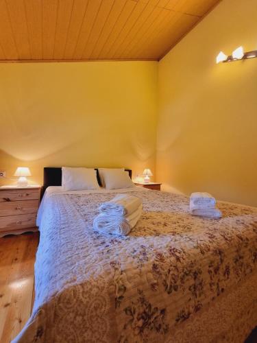 a bedroom with a large bed with white sheets and two lamps at Kuća za odmor Neli in Sukošan