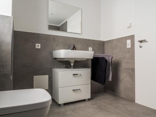 a bathroom with a sink and a toilet at Wohnung Forst in Forst