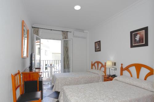 Postel nebo postele na pokoji v ubytování Hotel Oasis