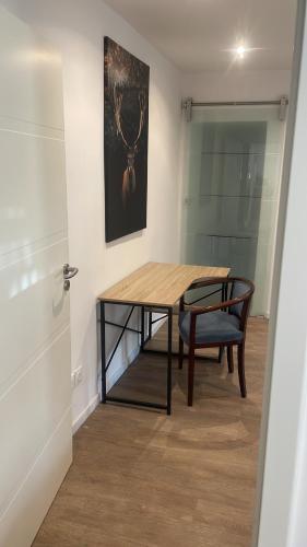a dining room with a table and a chair at Superbe Appartement au RDC avec cheminée in Villerupt