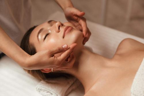a woman in a spa getting her face massage at Armagh City Hotel in Armagh