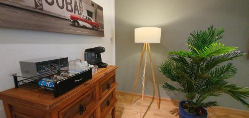 a room with a table with a lamp and a plant at Solitaire Hotel in Berlin