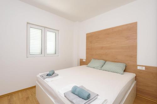 ジュリャナにあるPeninsula Apartmentsのベッドルーム(大きな白いベッド1台、窓付)