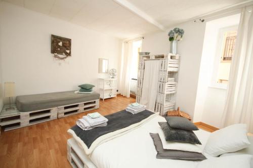 a white room with two beds and a ladder at Menaggio Centro in Menaggio